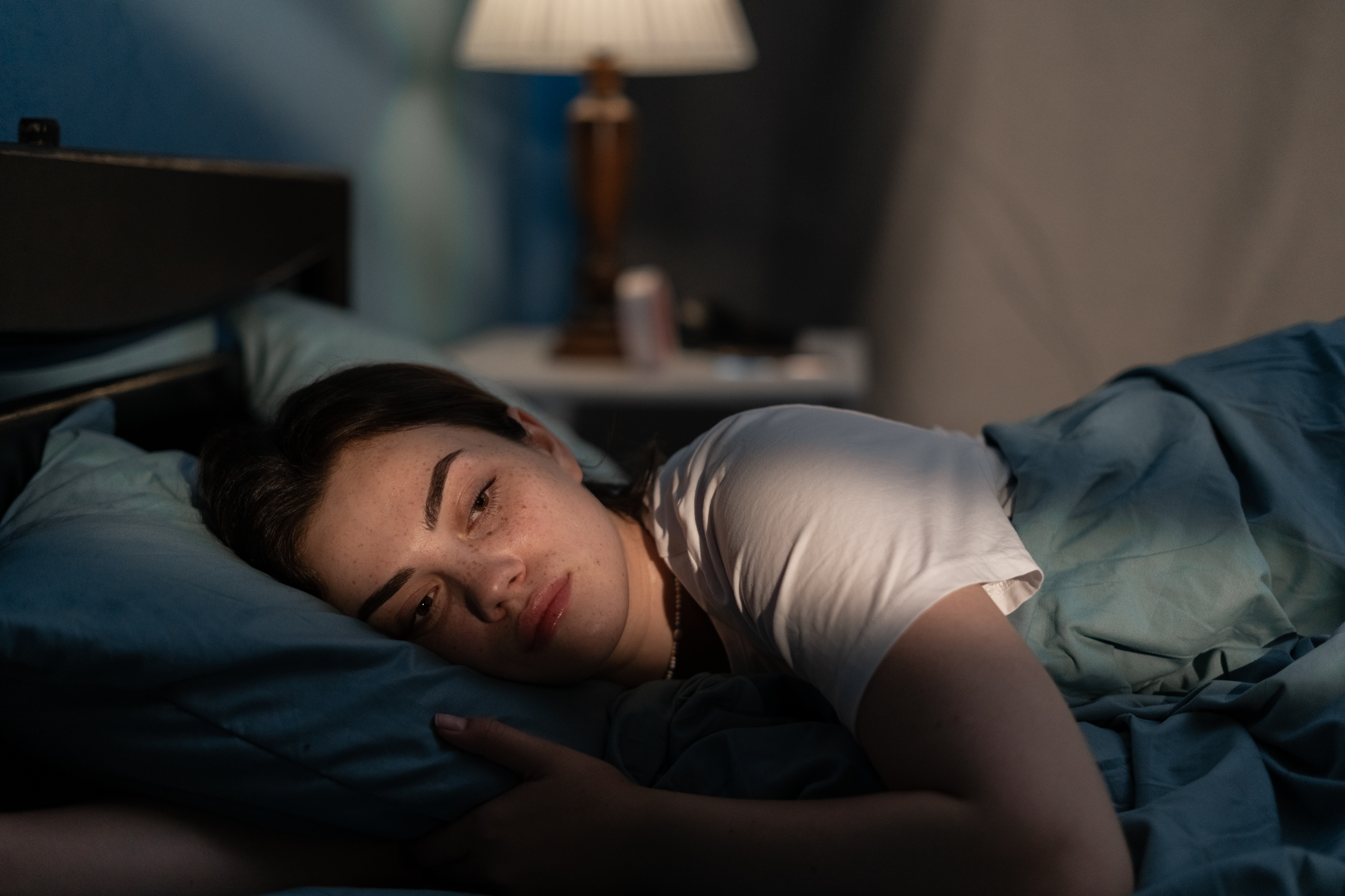 A woman contemplating something while lying in bed | Source: Getty Images