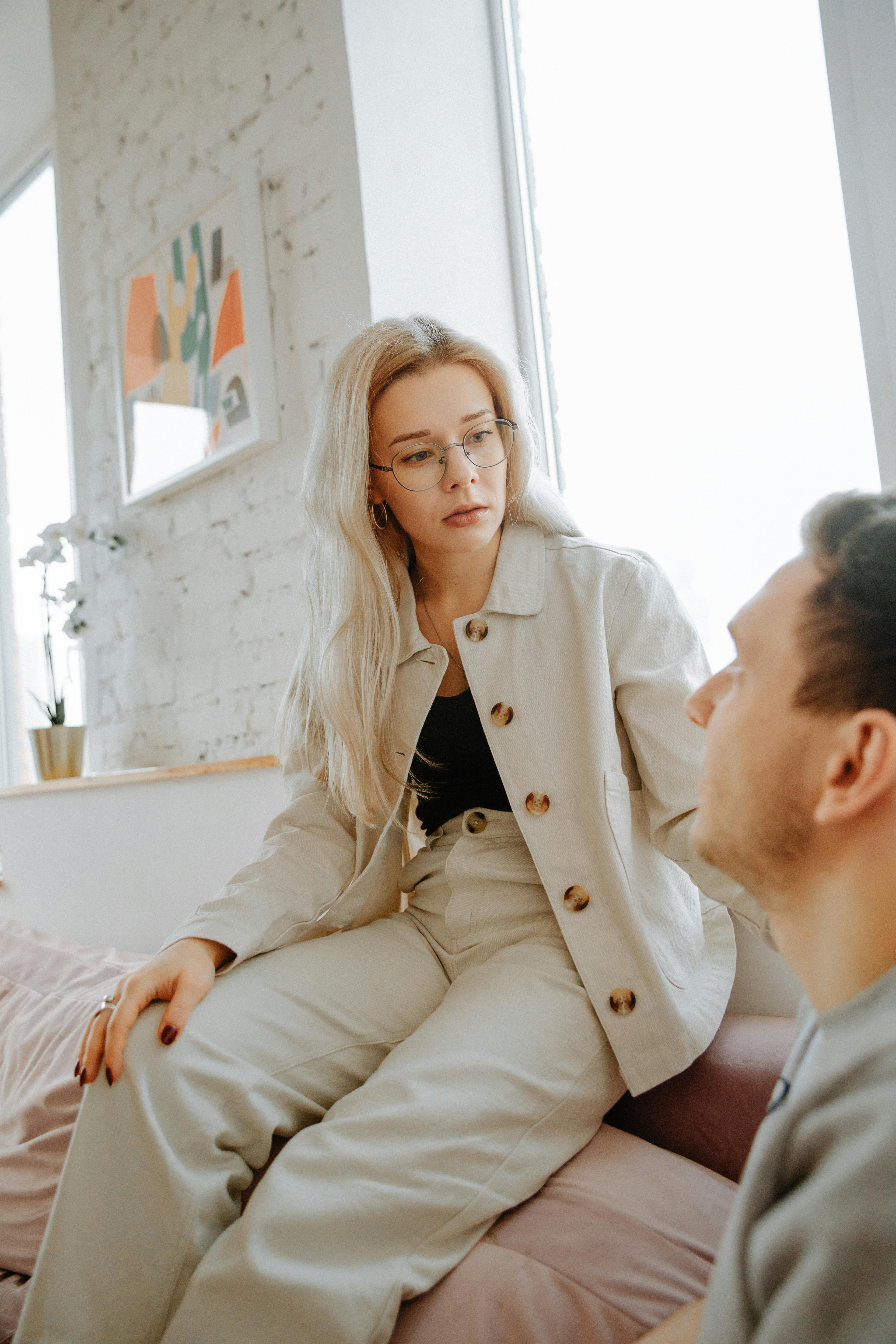 A woman looking distant while interacting with a man