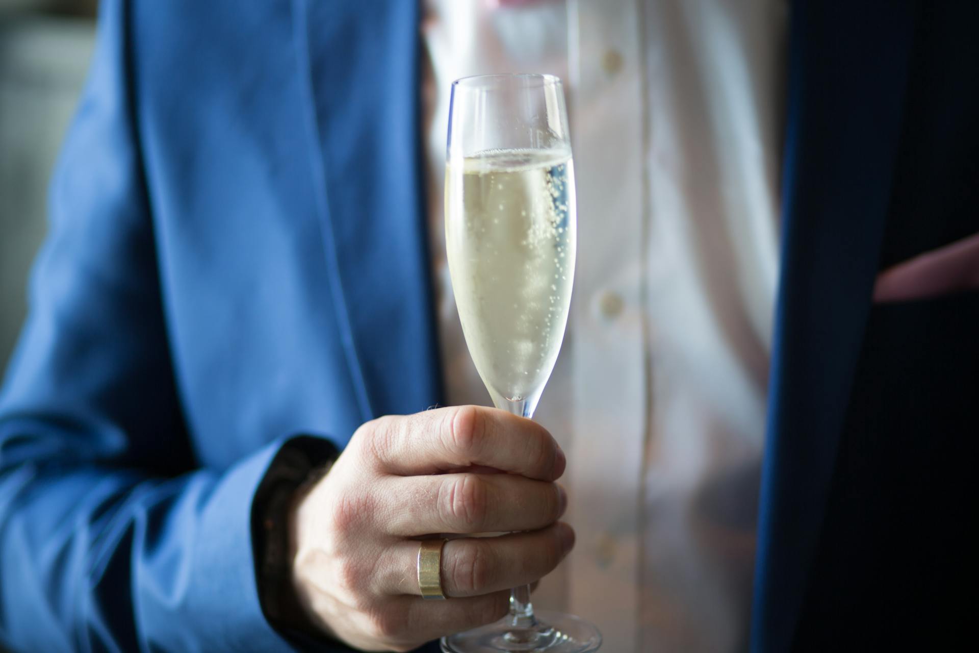 A man holding a glass of champagne