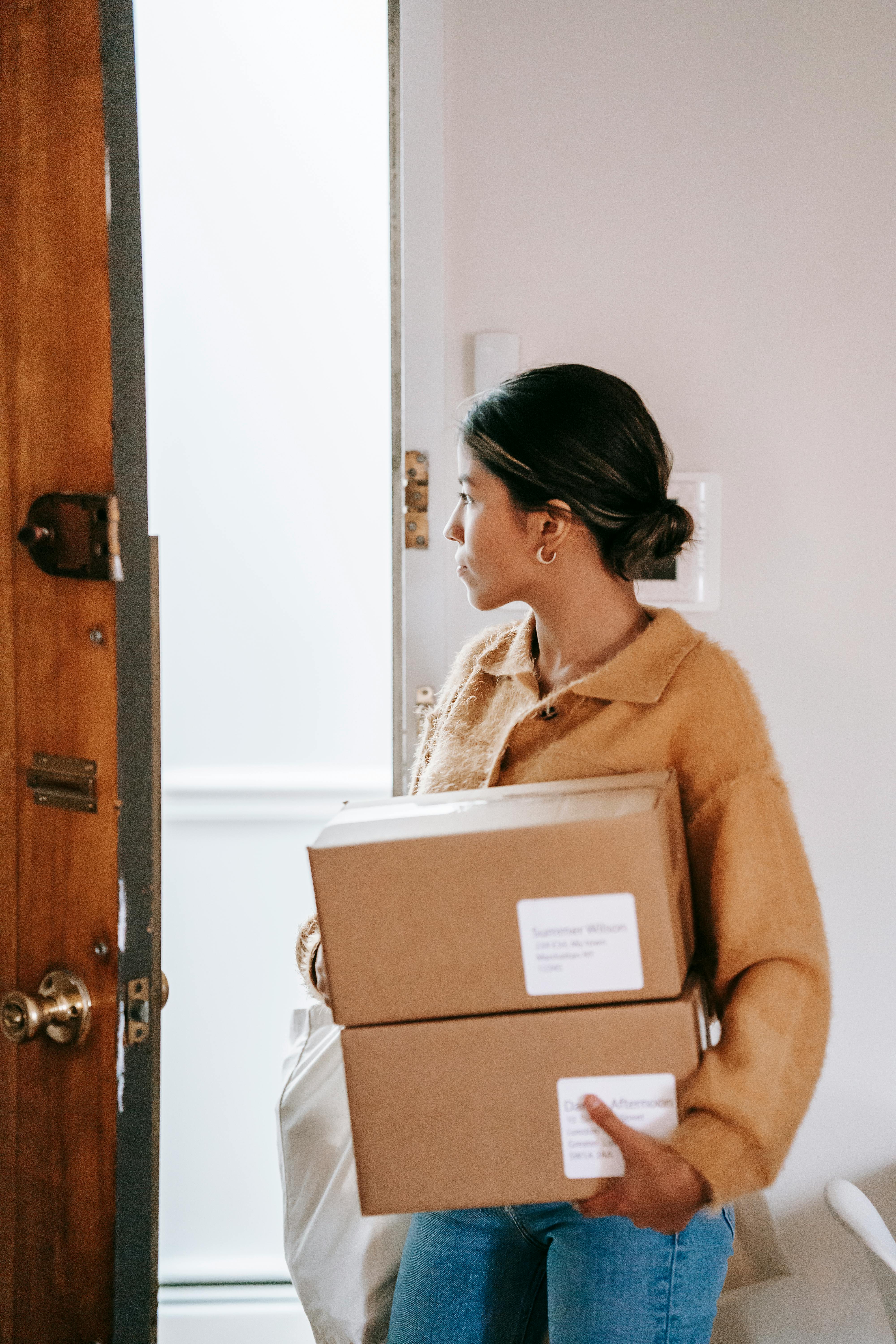 A woman exiting through a door | Source: Pexels