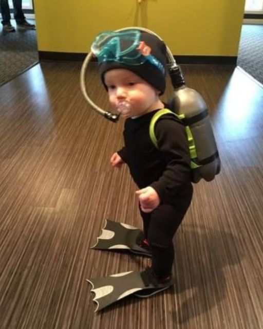 MY TODDLER WALKED INTO THE HOTEL ROOM WEARING A FULL SCUBA SUIT—AND I STILL HAVE NO IDEA WHERE HE GOT IT